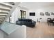 Open living room with large sliding glass doors, television, and modern decor at 62 Jasmine St, Denver, CO 80220