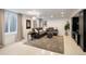 Cozy basement living room with a large sectional sofa, plush rug, and stylish decor for comfortable living at 62 Jasmine St, Denver, CO 80220