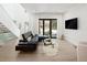 Bright living room with sliding glass door to back yard and staircase with glass railing at 62 Jasmine St, Denver, CO 80220