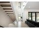 Stylish living area with floating staircase, large windows, and modern decor at 62 Jasmine St, Denver, CO 80220