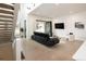 Spacious living room with modern staircase, large windows, and comfortable seating at 62 Jasmine St, Denver, CO 80220