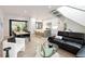 Open-concept living space featuring a modern kitchen and dining area with access to the outdoors at 62 Jasmine St, Denver, CO 80220