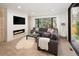 Cozy living room with fireplace, large window, and comfortable seating area at 62 Jasmine St, Denver, CO 80220