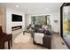 Cozy living room with fireplace, large window, and comfortable seating area at 62 Jasmine St, Denver, CO 80220