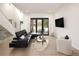 Bright living room with hardwood floors, modern furnishings, and sliding doors to the outdoors at 62 Jasmine St, Denver, CO 80220