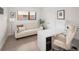 Bright home office with a white sofa, modern desk, and ample natural light for a comfortable workspace at 62 Jasmine St, Denver, CO 80220