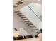 Modern staircase with hardwood steps and glass railing at 62 Jasmine St, Denver, CO 80220