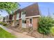 Two-story brick townhouse with flower bed in front at 12956 W Virginia Ave, Lakewood, CO 80228