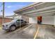 Covered parking space featuring an access door for parking convenience at 12956 W Virginia Ave, Lakewood, CO 80228