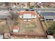Aerial view of the home showing a backyard with patio, shed and access to surrounding neighborhood at 1436 S Yates St, Denver, CO 80219