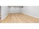 Large basement area with light wood-look floors, pot lights, and white-painted walls at 1436 S Yates St, Denver, CO 80219