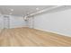Bright basement with light wood-look floors and pot lighting at 1436 S Yates St, Denver, CO 80219