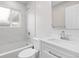 Clean bathroom features a shower-tub, tiled walls, and vanity with sink at 1436 S Yates St, Denver, CO 80219