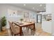 Elegant dining room featuring a wood table, six chairs, and lots of natural light at 1436 S Yates St, Denver, CO 80219
