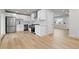 Modern kitchen with white cabinets, stainless steel appliances, and light wood flooring at 1436 S Yates St, Denver, CO 80219