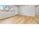 Neutral living room with wood floors, a large window, and a view of the outdoors at 1436 S Yates St, Denver, CO 80219