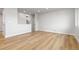 Open-concept living area with light flooring and views to the kitchen at 1436 S Yates St, Denver, CO 80219