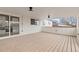 Covered patio with wooden deck, access to kitchen, and open views of the surrounding neighborhood at 1436 S Yates St, Denver, CO 80219