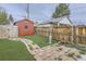 A backyard features artificial turf, a brick and stone walkway, a metal patio heater and a wooden privacy fence at 4910 W 34Th Ave, Denver, CO 80212