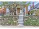 Charming brick home with a large tree in the front yard and inviting front porch at 4910 W 34Th Ave, Denver, CO 80212