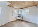 Bright room featuring a wooden ceiling, light wood floors and a sleek black writing desk beneath a mini-split AC unit at 4910 W 34Th Ave, Denver, CO 80212