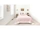 Cozy bedroom with pink bedspread, light-colored walls, and natural light at 5025 Central Park Blvd, Denver, CO 80238