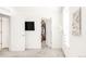 Bright bedroom with a large window, walk-in closet, mounted tv, and light walls at 5025 Central Park Blvd, Denver, CO 80238