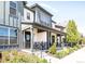 Charming home with a cozy front porch, showcasing stylish architecture and well-maintained landscaping at 5025 Central Park Blvd, Denver, CO 80238