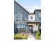 Close up of a modern home with vertical siding, windows and a charming front porch at 5025 Central Park Blvd, Denver, CO 80238
