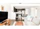 Open-concept living space featuring a cozy sofa, dining area, and a glimpse of the kitchen at 5025 Central Park Blvd, Denver, CO 80238