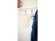 Entryway mudroom features coat hooks and a shelf for storage and organization at 5025 Central Park Blvd, Denver, CO 80238
