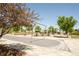 Outdoor lounge area with tables, trees, and shade canopies at 5025 Central Park Blvd, Denver, CO 80238