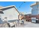 Private backyard area complete with string lights, patio furniture, a grill and wood privacy fence at 8381 E 29Th Ave, Denver, CO 80238