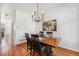 Dining room with hardwood floors, wood table, modern light fixture and colorful artwork for elegant dining at 8381 E 29Th Ave, Denver, CO 80238