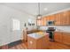 Inviting kitchen featuring stainless steel appliances, wood cabinets, and island at 8381 E 29Th Ave, Denver, CO 80238