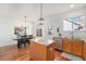 Bright kitchen featuring stainless steel appliances, wooden cabinets, and an island with butcher block countertop at 8381 E 29Th Ave, Denver, CO 80238