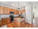 Modern kitchen with stainless appliances, wood cabinets, and convenient center island at 8381 E 29Th Ave, Denver, CO 80238