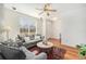 Cozy living room with hardwood floors, a large window, and comfortable seating at 8381 E 29Th Ave, Denver, CO 80238