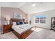 Spacious main bedroom with a vaulted ceiling, large window, carpet floors, and contemporary decor at 8381 E 29Th Ave, Denver, CO 80238