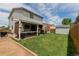 Expansive backyard featuring a storage shed, patio, and lush green lawn at 6119 Zenobia Ct, Arvada, CO 80003