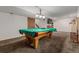 Finished basement featuring carpet, a pool table with a green felt cover, and a mounted TV at 6119 Zenobia Ct, Arvada, CO 80003
