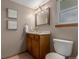 Cozy bathroom with a classic vanity, decorative mirror, and neutral color scheme, creating a relaxing atmosphere at 6119 Zenobia Ct, Arvada, CO 80003
