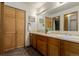 Functional bathroom with a double sink vanity, ample storage, and neutral decor, designed for convenience and comfort at 6119 Zenobia Ct, Arvada, CO 80003
