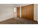 Bedroom showing closet and door leading to another room with a staircase at 6119 Zenobia Ct, Arvada, CO 80003