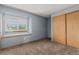 Inviting bedroom with a window seat, closet, and soft carpeting, offering a blend of comfort and functionality at 6119 Zenobia Ct, Arvada, CO 80003
