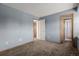Simple and spacious bedroom featuring soft carpet, neutral walls, and multiple access points, perfect for customization at 6119 Zenobia Ct, Arvada, CO 80003