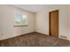 Bright bedroom featuring neutral walls, carpet, and a window with shutter-style blinds for natural light at 6119 Zenobia Ct, Arvada, CO 80003