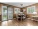 Cozy dining area with hardwood floors, ample light, and seating for four at 6119 Zenobia Ct, Arvada, CO 80003