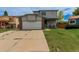 Charming two-story home with a spacious two-car garage and well-maintained lawn at 6119 Zenobia Ct, Arvada, CO 80003