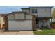 Two-story home with neutral siding, two car garage, and a cozy covered porch at 6119 Zenobia Ct, Arvada, CO 80003